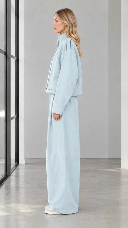 Side profile view of woman wearing Light Blue cropped jacket and matching wide leg trousers
