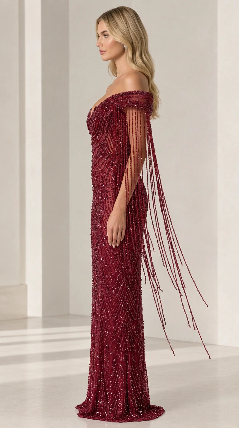 Side angle of burgundy beaded formal dress showcasing cascading fringe sleeve