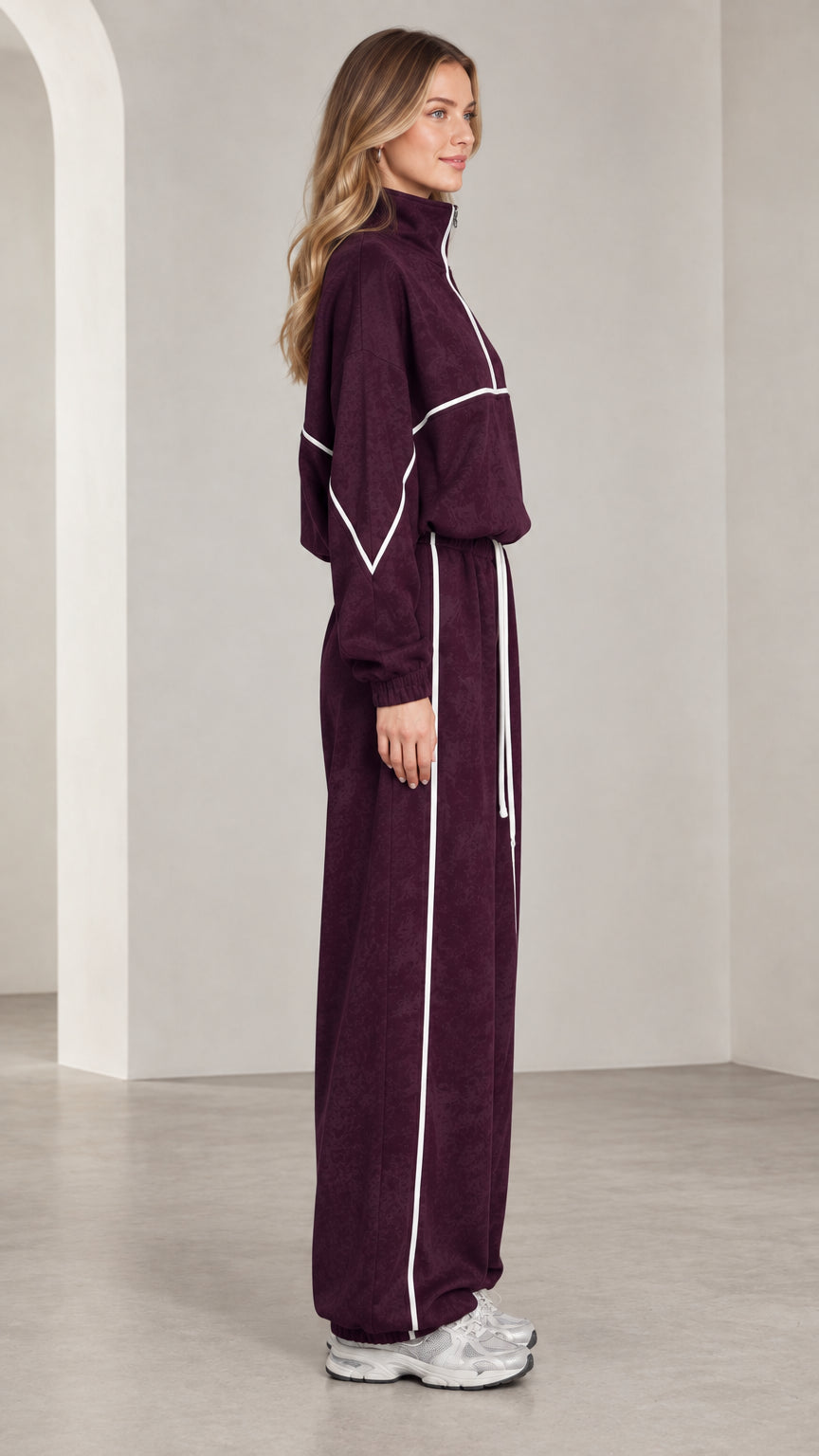 Side view of woman in burgundy 2-piece lounge tracksuit set
