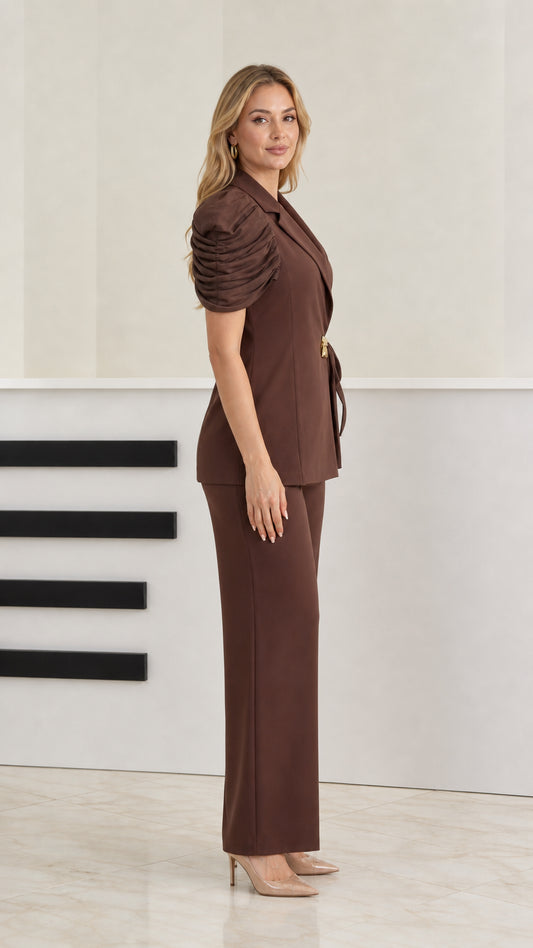 Side profile of model wearing brown 2-piece tailored pant suit set
