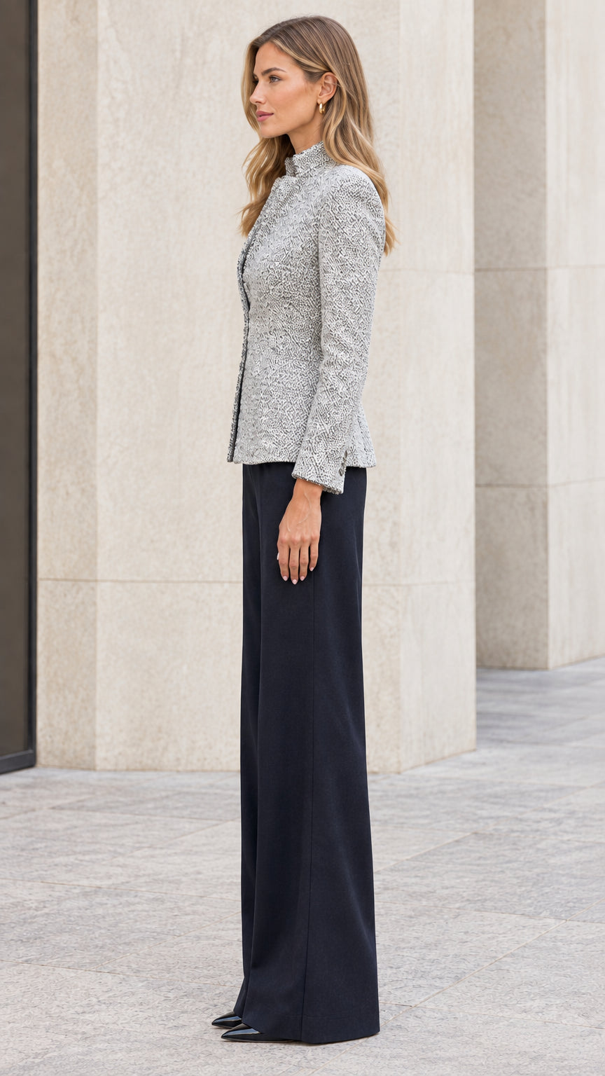 Side profile of model wearing grey textured stand collar blazer