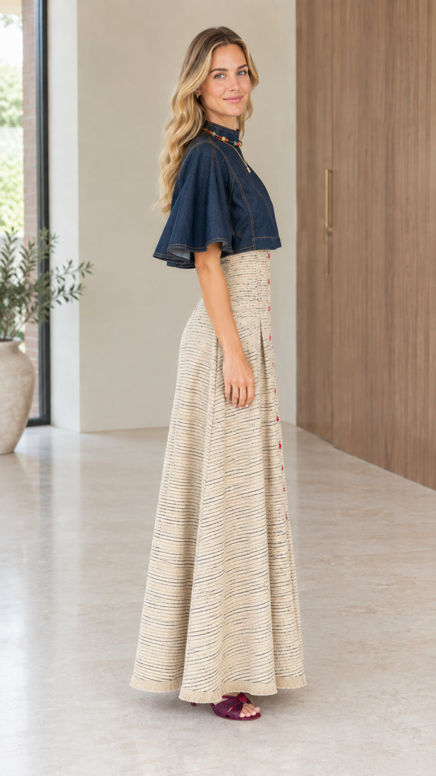 Side profile view of beige tweed maxi dress showing high-rise waistline and flutter sleeves