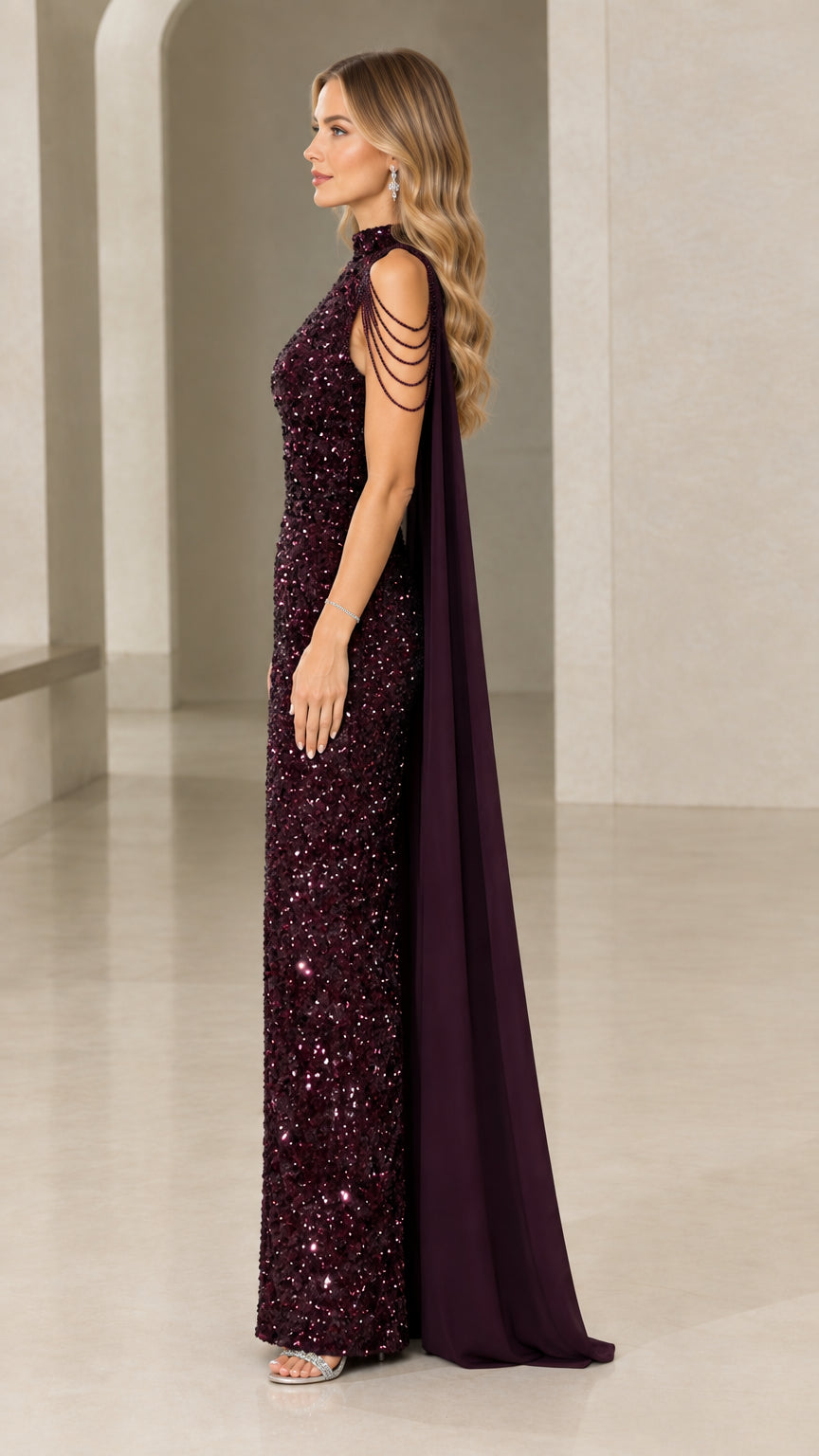 Side view of burgundy sequin floor-length formal dress showing flowing chiffon cape