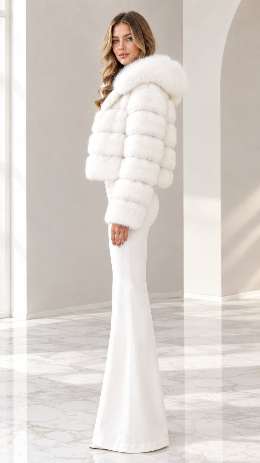 Side angle view of model wearing white hooded cropped faux fur jacket