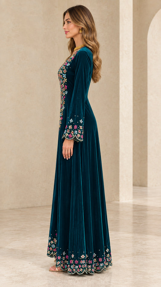 Side profile view of teal velvet long sleeve embroidered gown