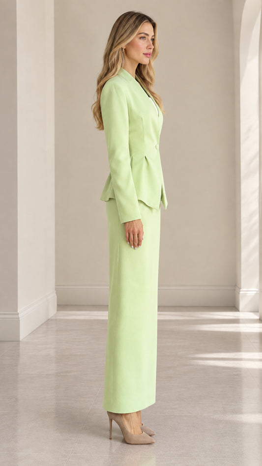 Side profile of model in mint green tailored peplum skirt suit