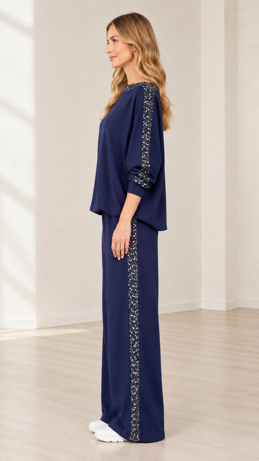 Side profile view of navy blue sequin trim matching lounge set with wide leg pants