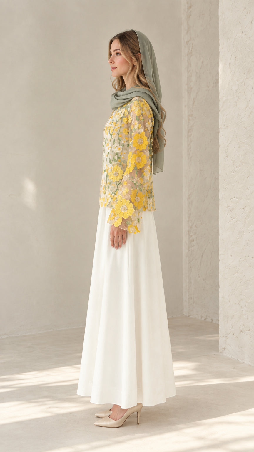 Side view of model wearing white modest dress set with floral embroidered overlay
