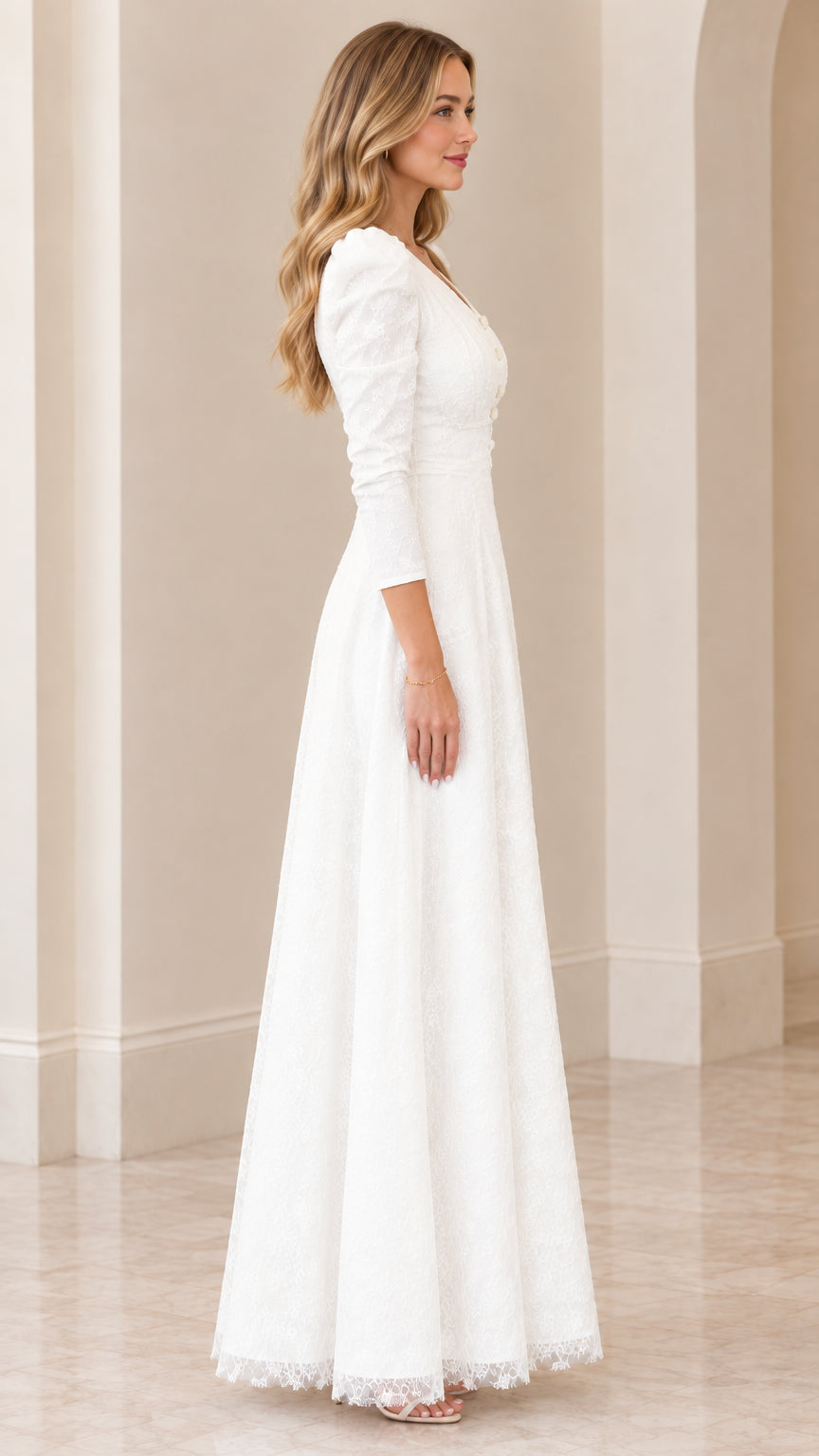 Side view of woman posing in floor-length white lace formal dress