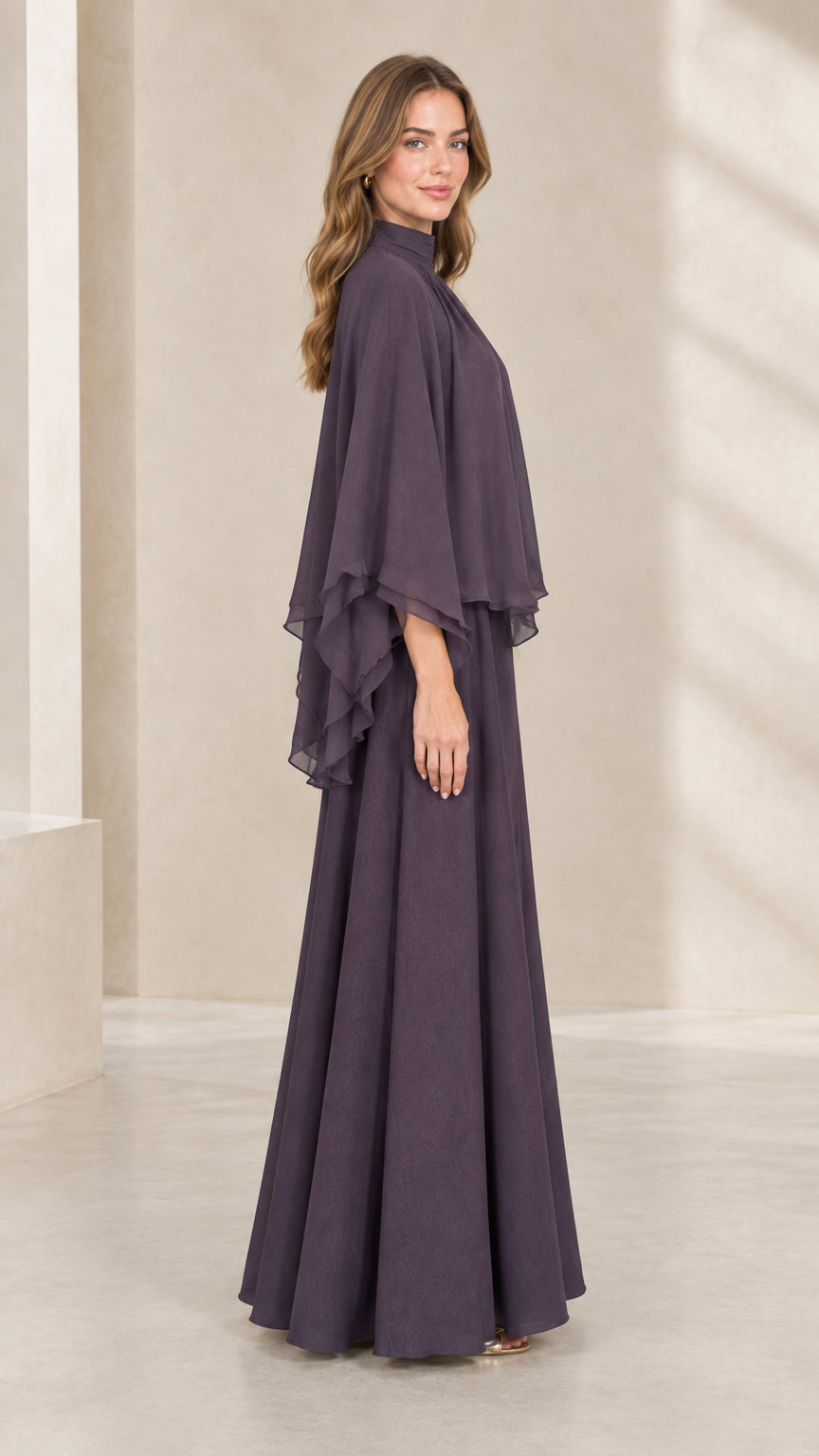 Side profile view of woman wearing dusty plum capelet evening gown