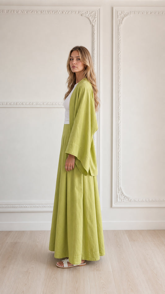 Side profile of woman in lime green 2-piece wide sleeve cardigan and pant set