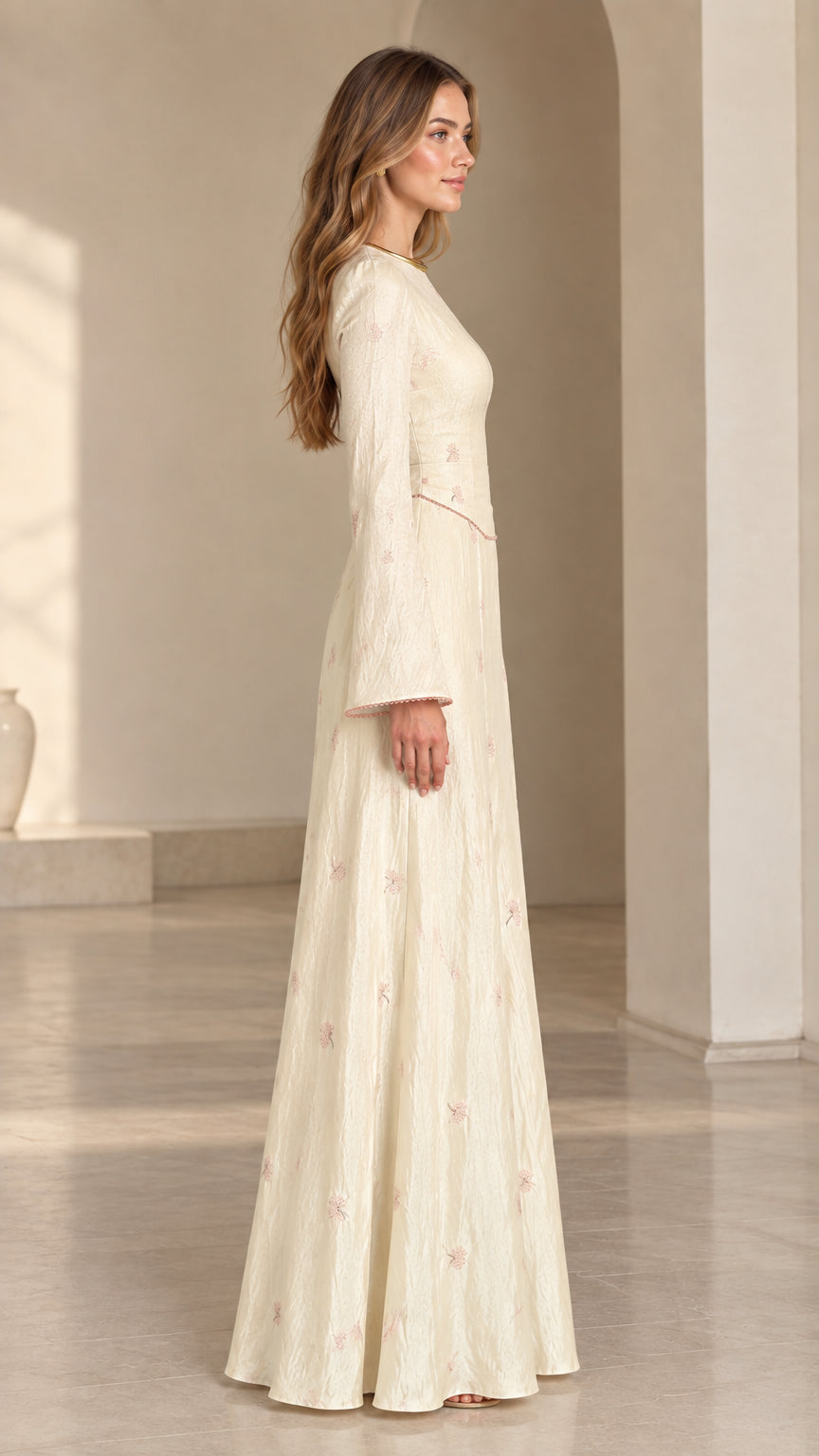 Side profile view of model wearing cream floral jacquard bell sleeve maxi dress