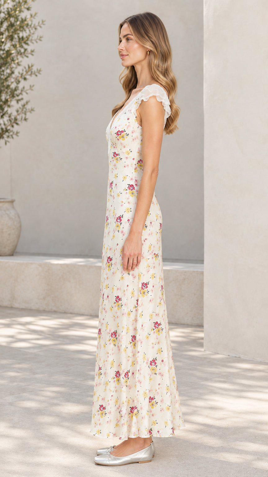 Side profile of woman wearing cream floral flutter sleeve maxi dress