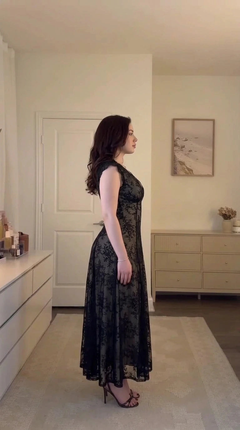 Side profile view of model wearing black floral lace corset midi dress