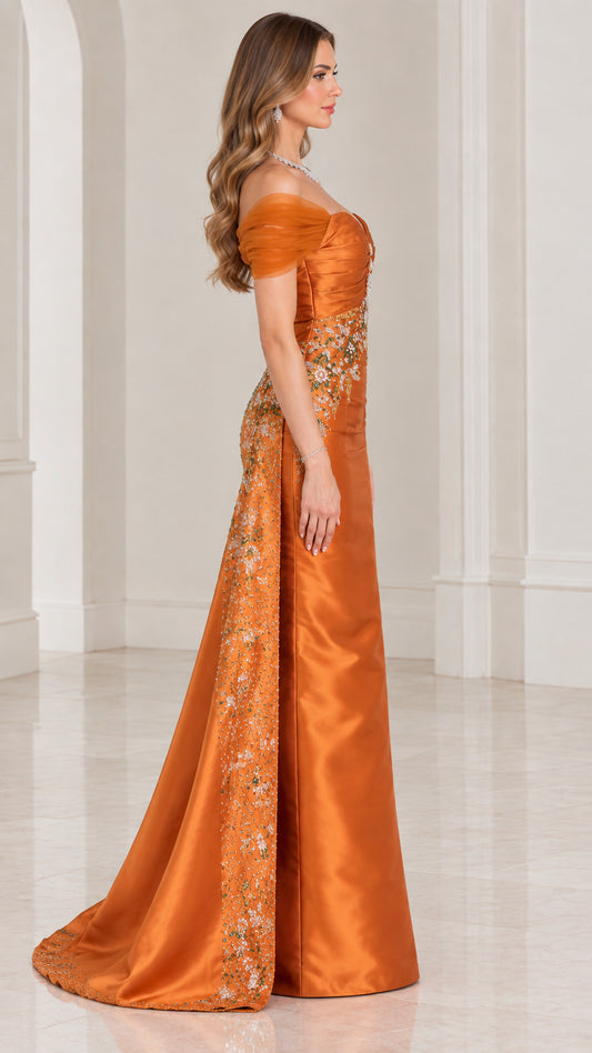 Side profile of rust orange formal gown showing embellished overskirt drape