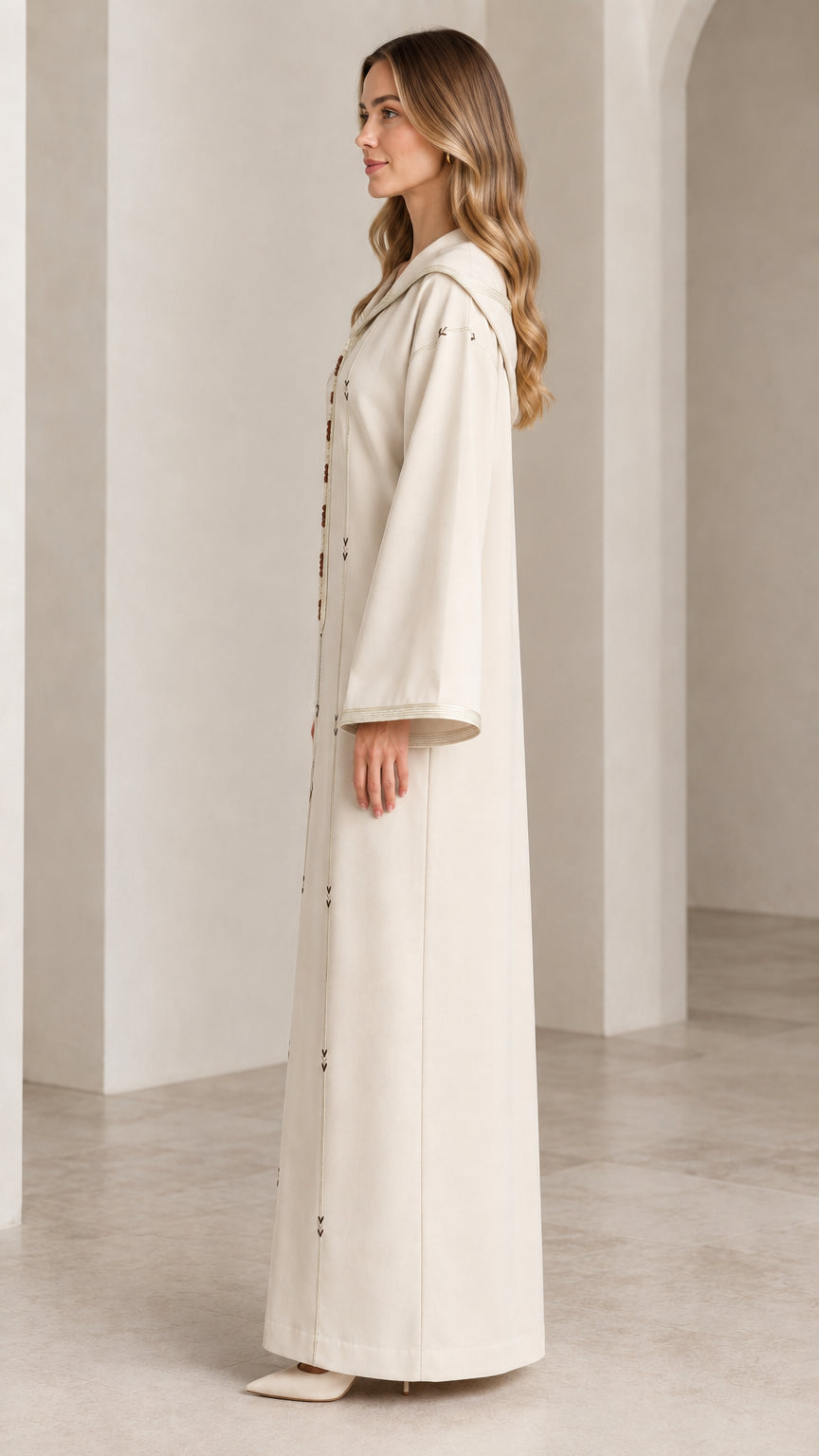 Side profile view of woman modeling cream hooded kaftan maxi dress with wide sleeves