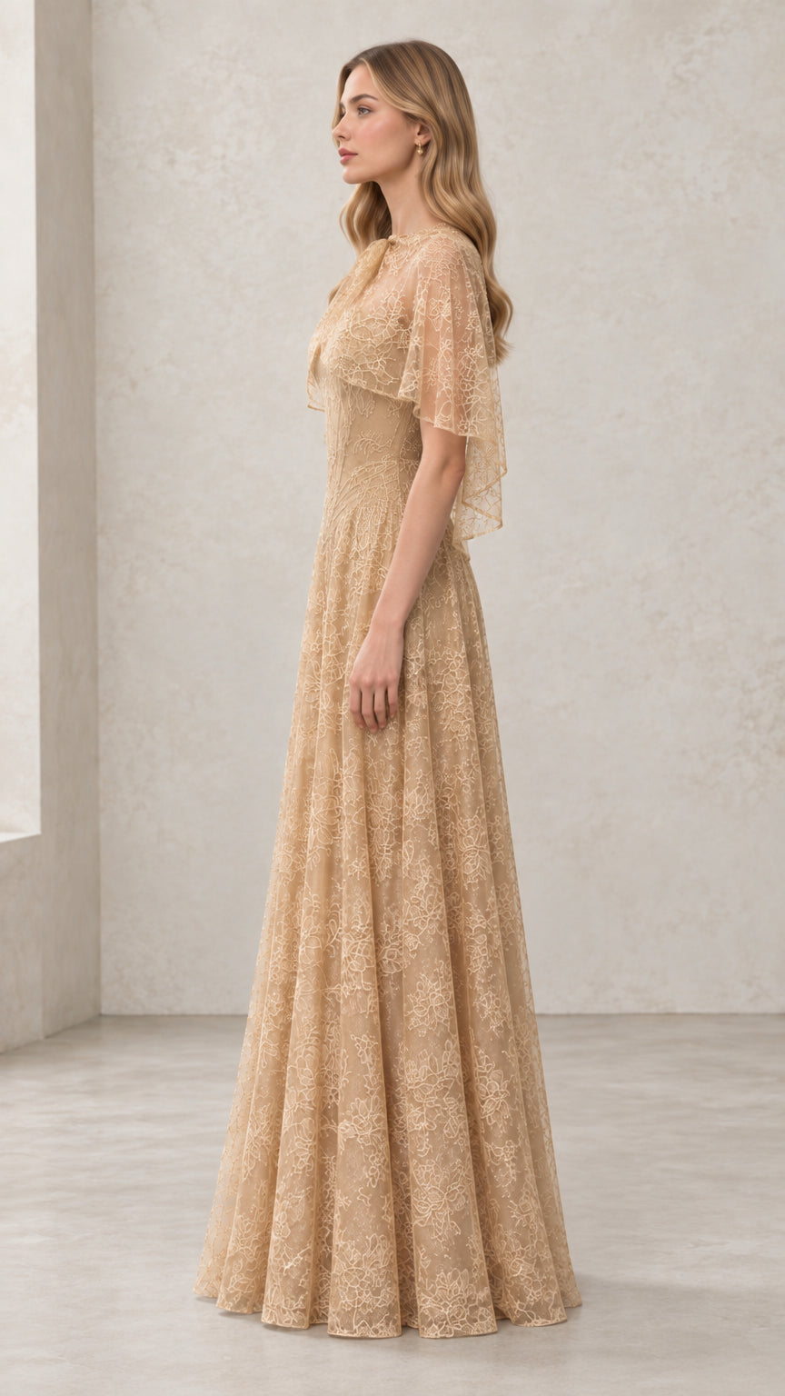 Side profile of woman in Champagne floral lace maxi dress with sheer capelet
