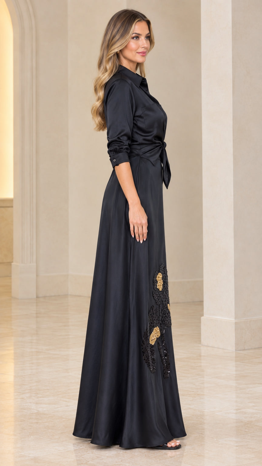 Side profile view of black satin long sleeve maxi shirt dress with waist tie