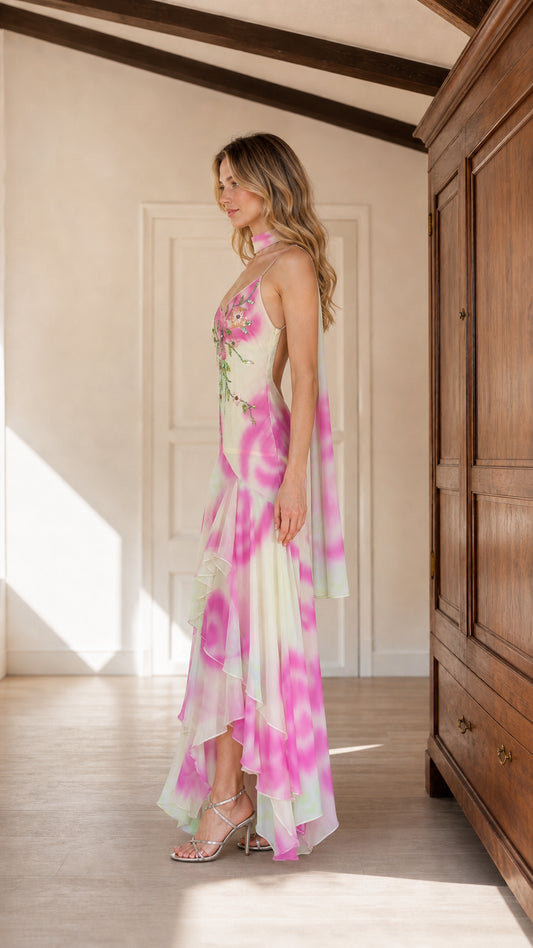 Side view of pink watercolor embroidered dress showing open back and tiered hem