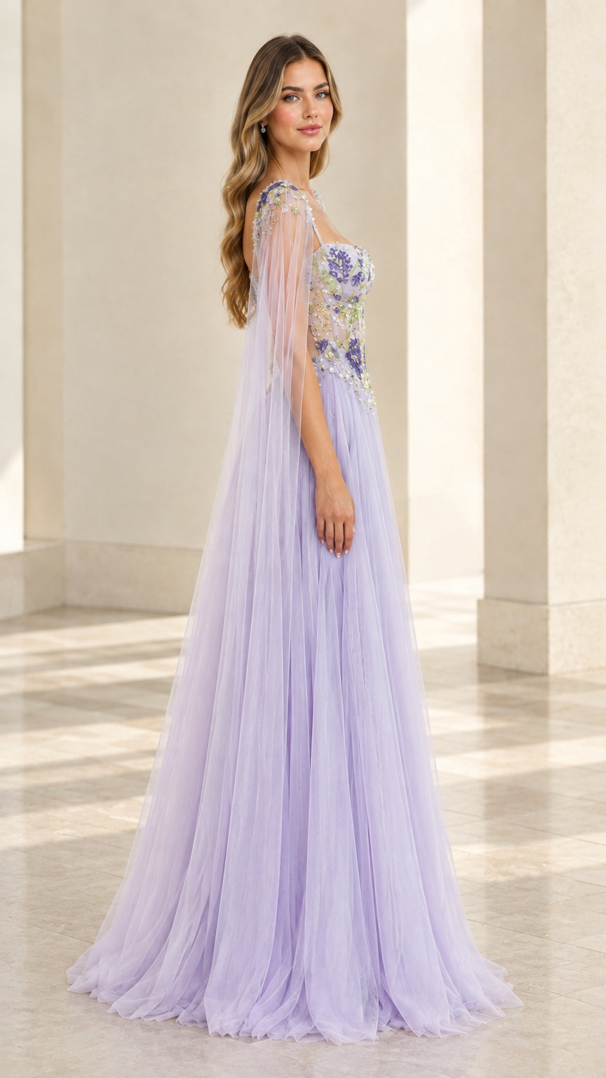 Side profile of lavender tulle A-line formal gown showing cape sleeve drape