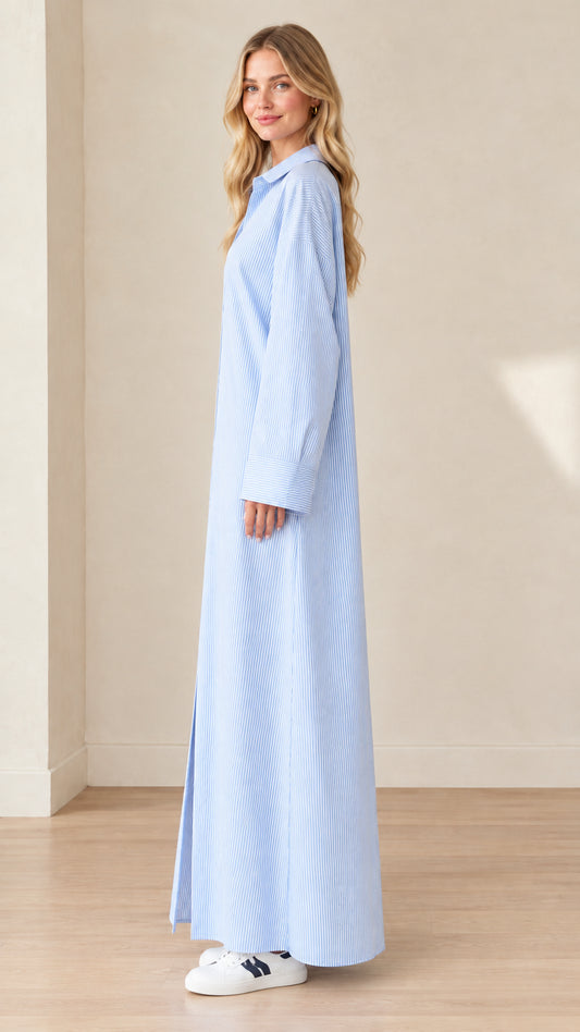 Side profile view of a model in a light blue striped long-sleeve maxi shirt dress