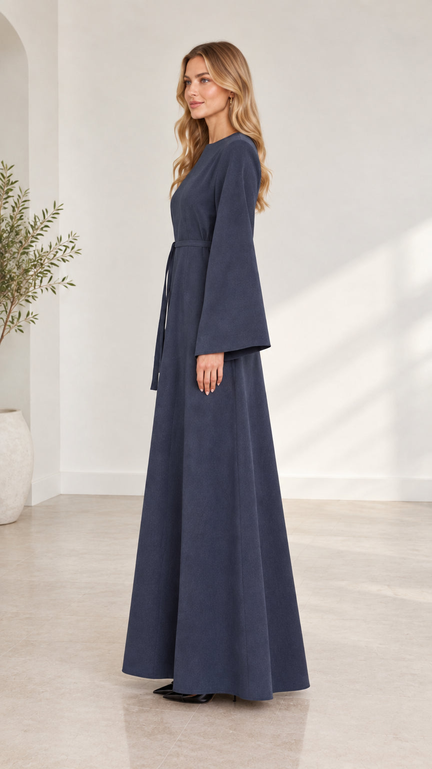 Side profile view of woman wearing navy blue flared sleeve A-line maxi dress