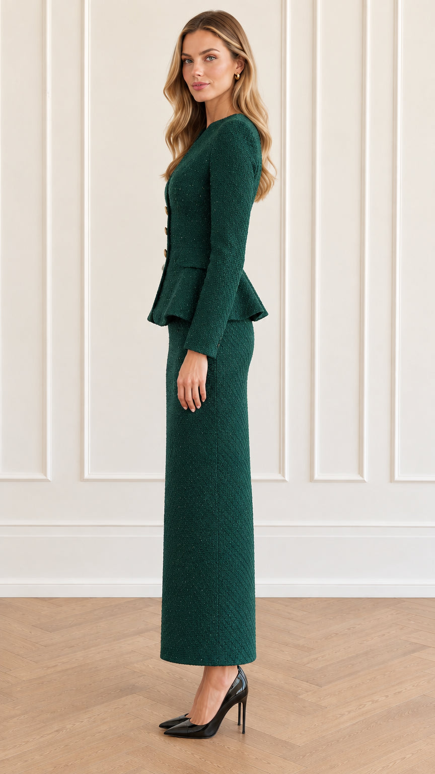 Side profile of model wearing emerald green tweed peplum skirt suit
