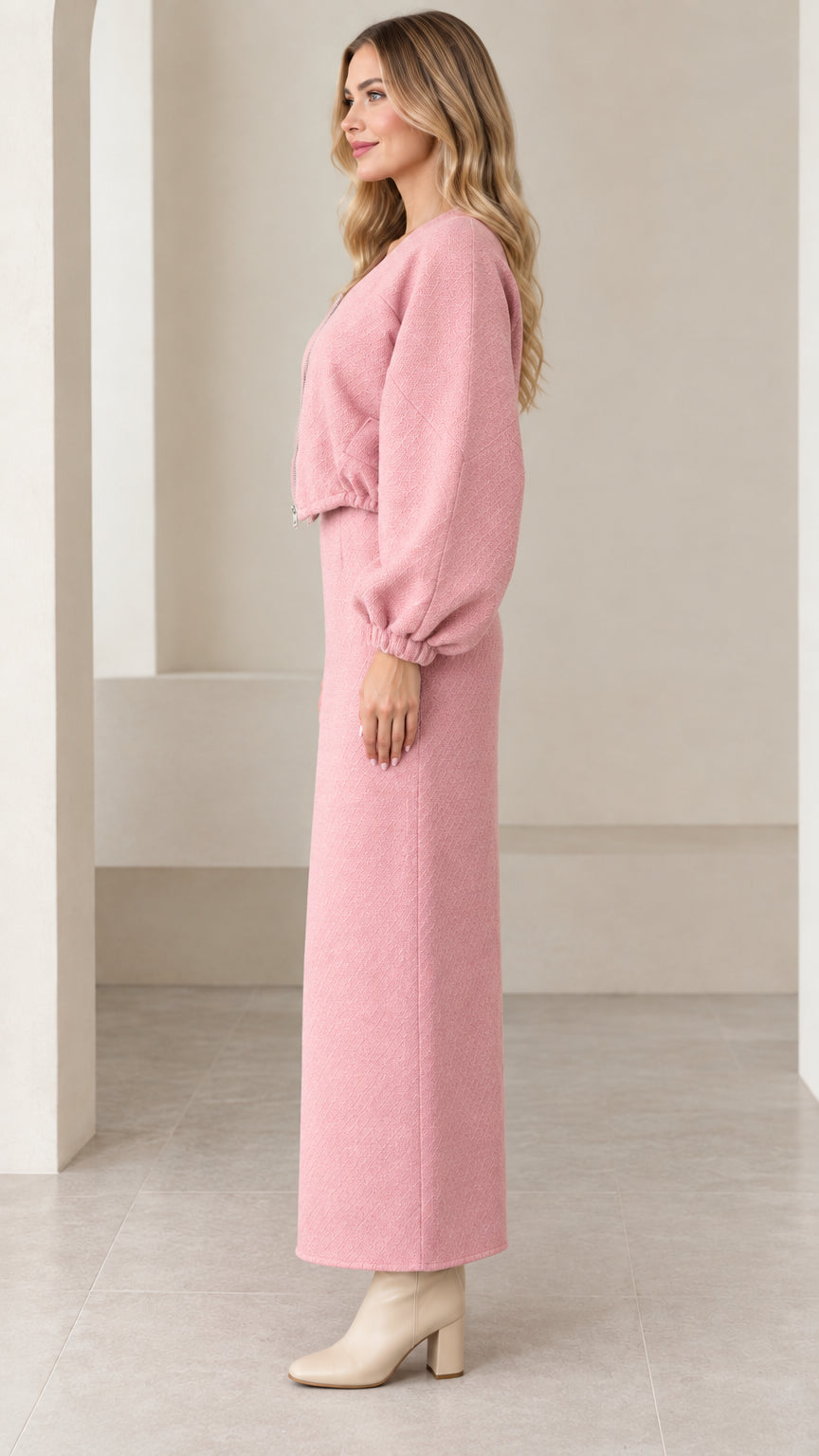 Side profile of model in pink two-piece jacket and skirt set