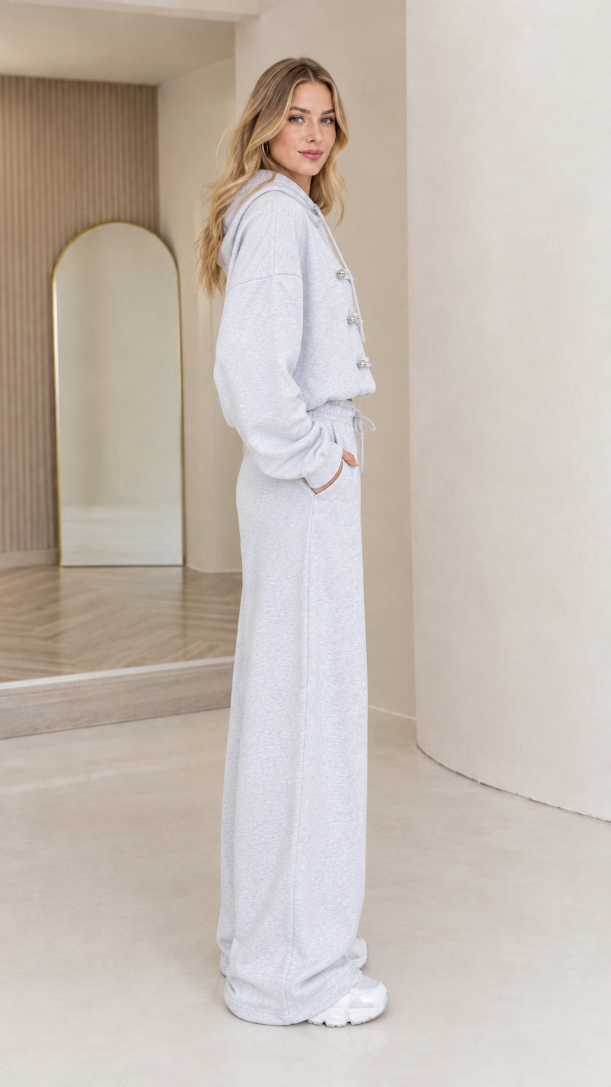 Side full-body view of light grey hoodie and sweatpants loungewear set