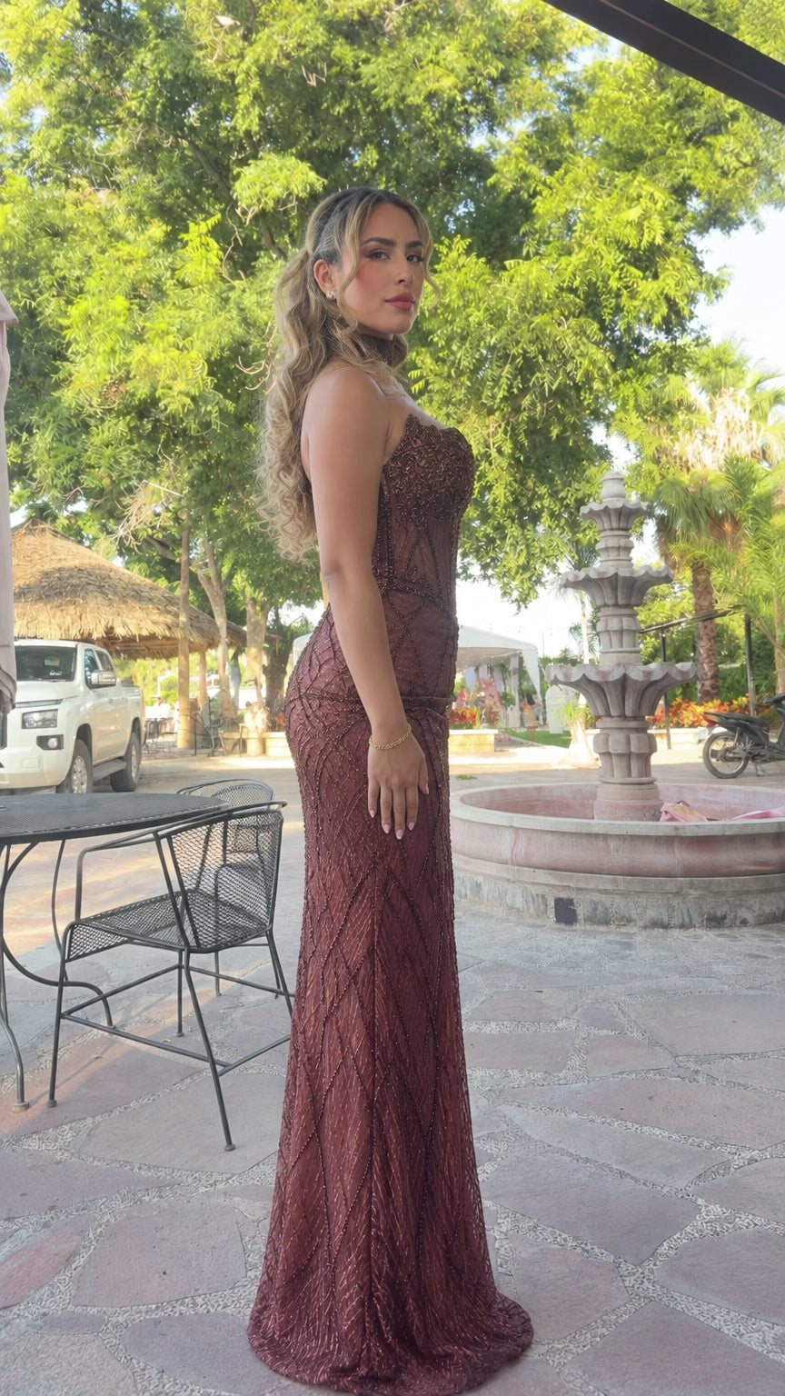 Side profile of burgundy beaded mermaid formal dress showing silhouette