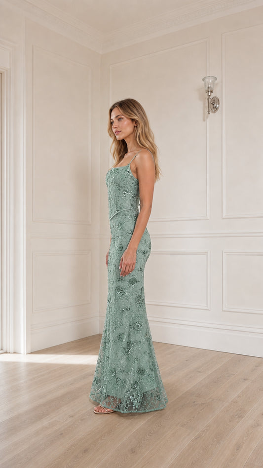 Woman wearing sage green sequin embroidered corset maxi dress, side profile