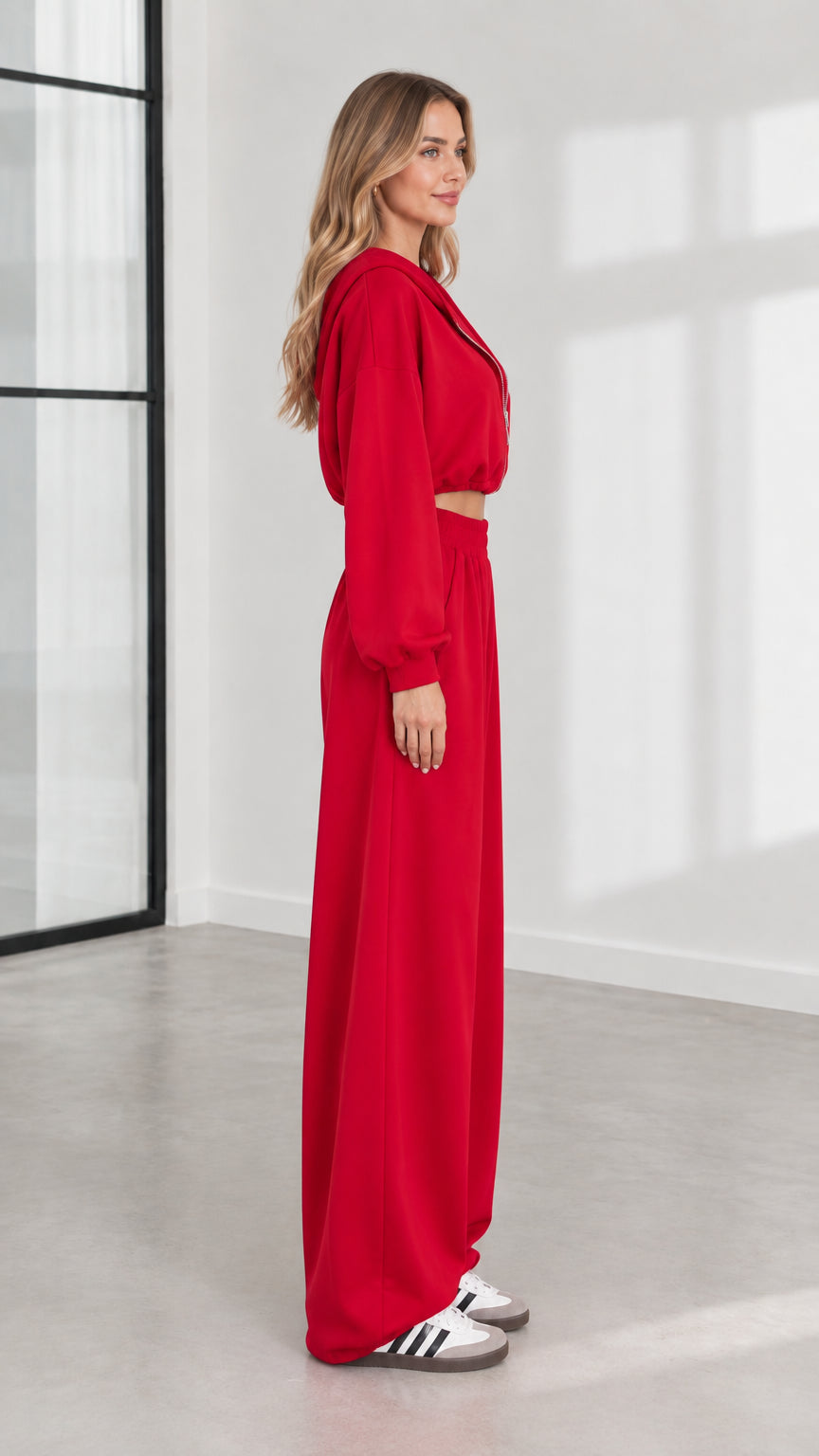 Side profile of model in red cropped hoodie and wide-leg pants set