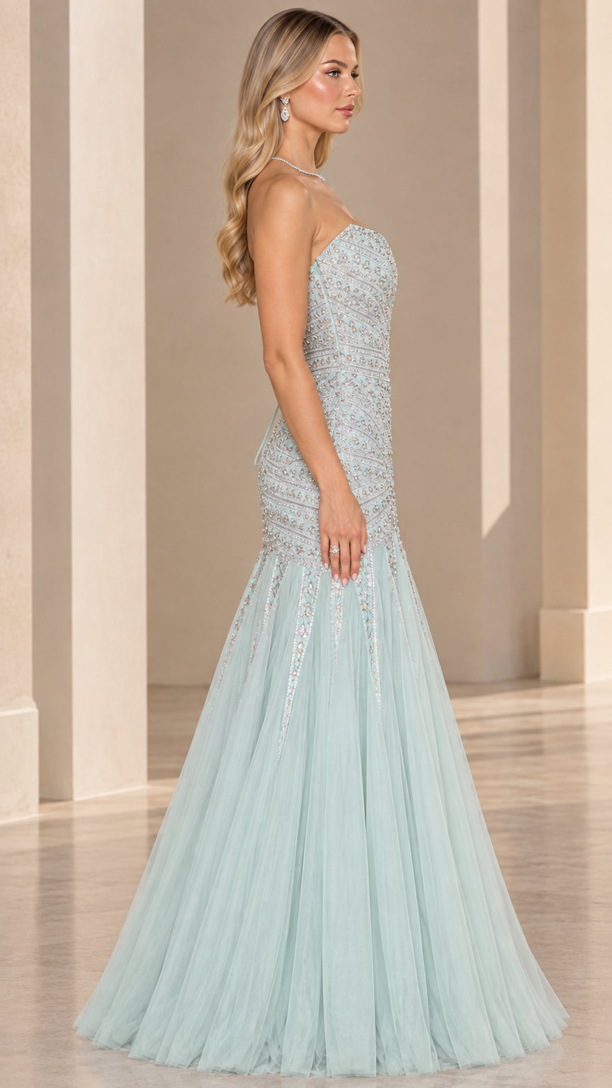 Side profile view of mint green strapless embellished mermaid evening gown