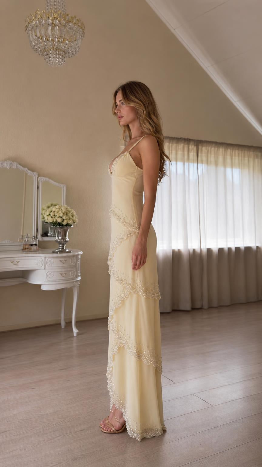 Side profile of yellow tiered formal gown