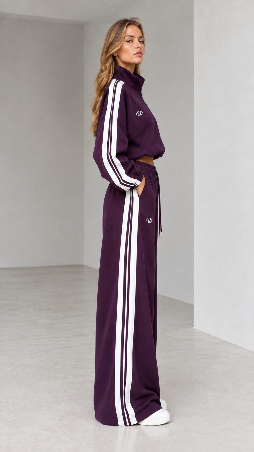 Side profile of woman in deep plum two-piece wide-leg sweatsuit set