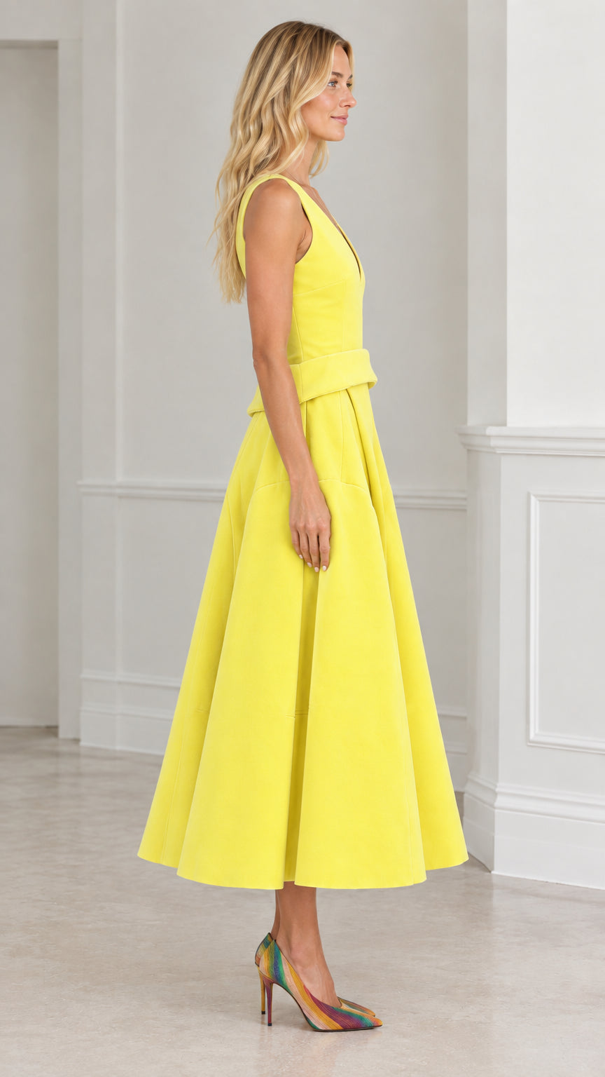 Side view of yellow sleeveless pleated midi dress