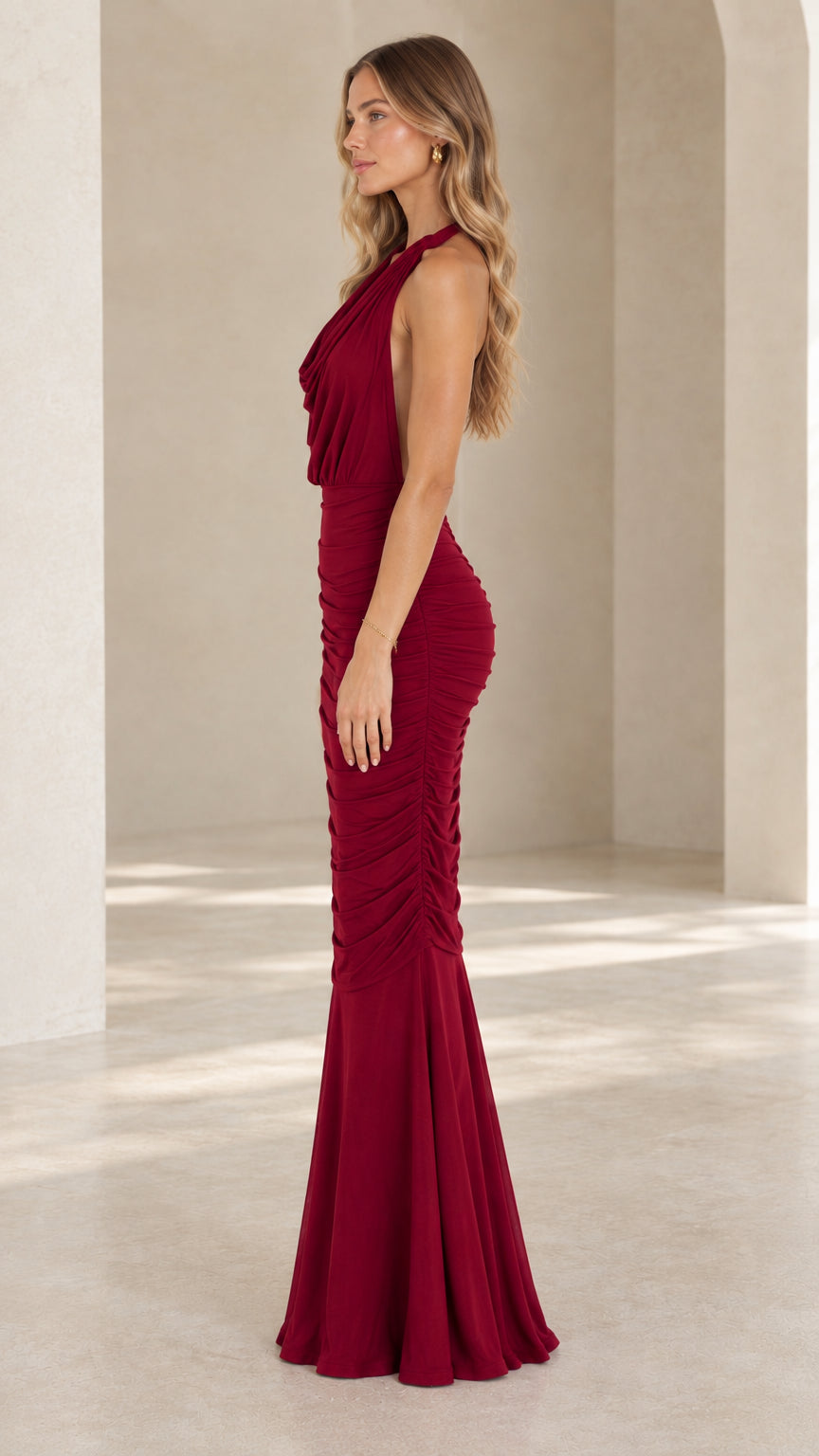 Side profile view of burgundy ruched halter floor length evening dress