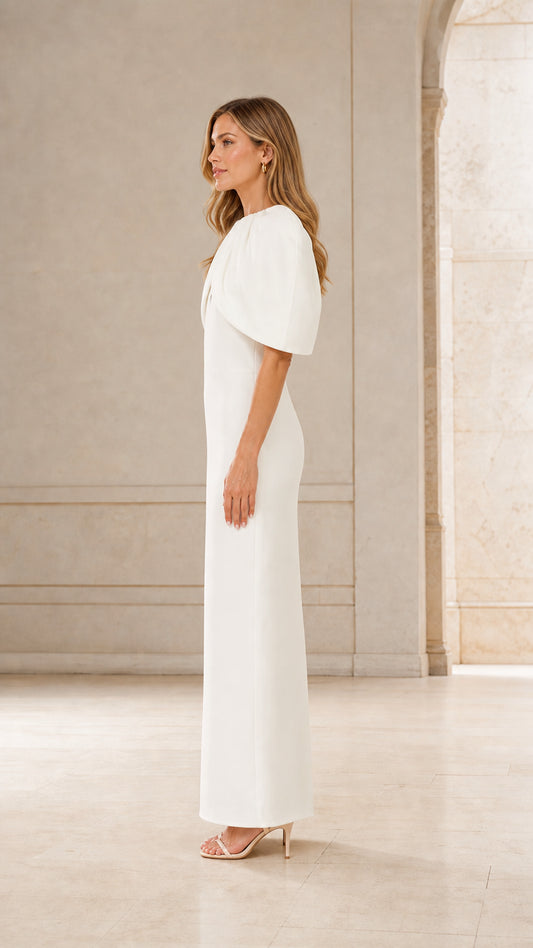 Side profile of woman in white formal cape dress