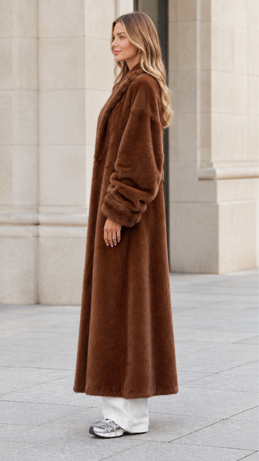 Side profile view of woman modeling chocolate brown maxi faux fur coat