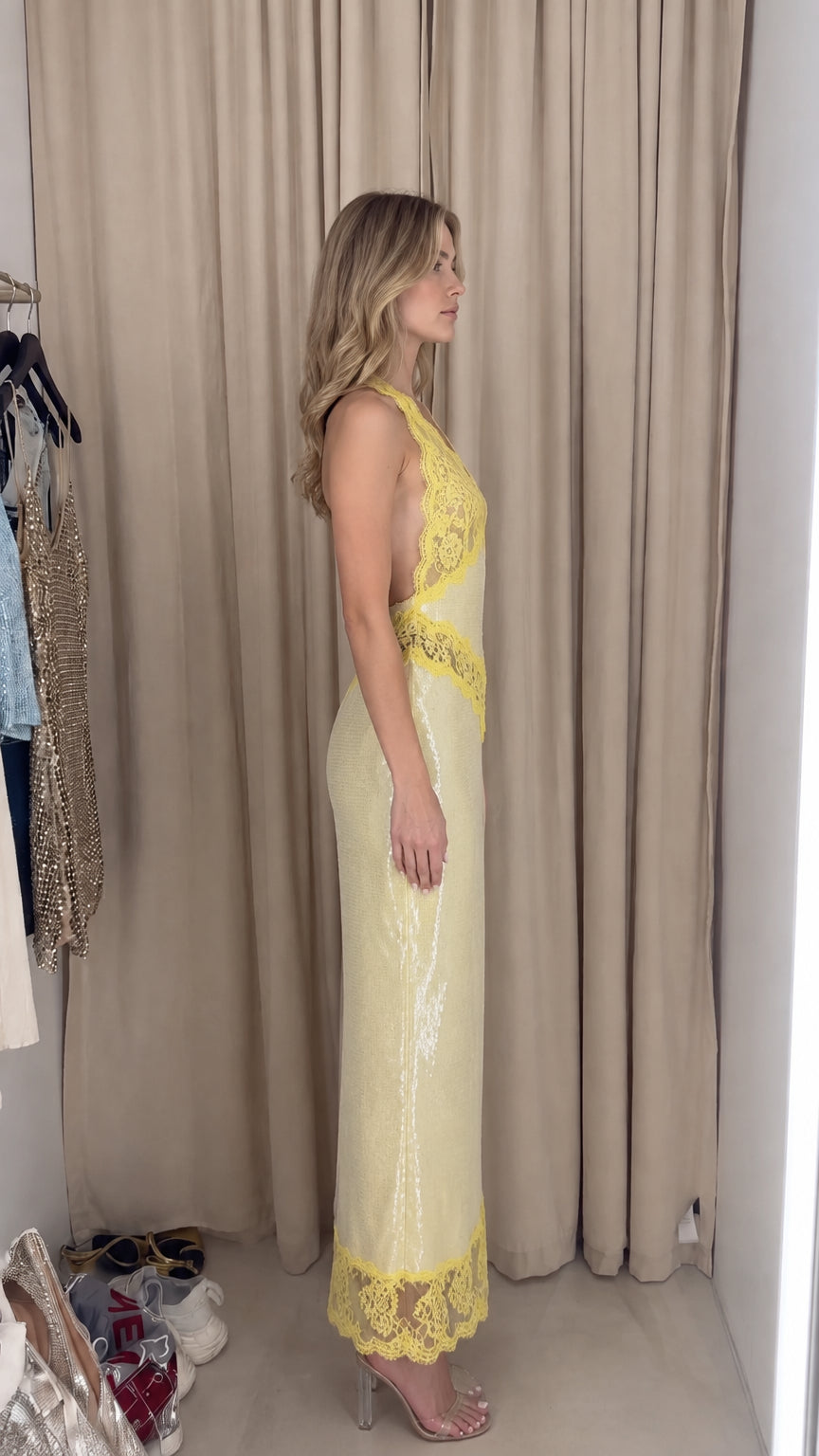Side view of model in Pale Yellow sequin halter dress showing silhouette and fit