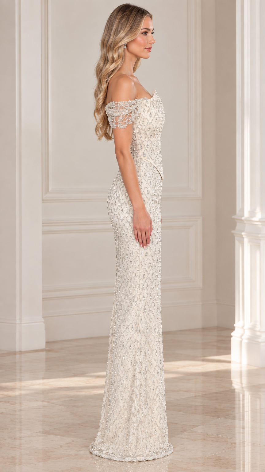 Side profile of model in full-length ivory beaded formal gown with cap sleeves