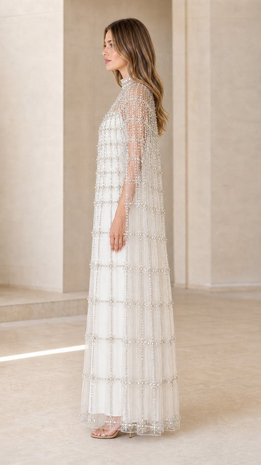 Side profile of model in Ivory White crystal-embellished cape maxi dress