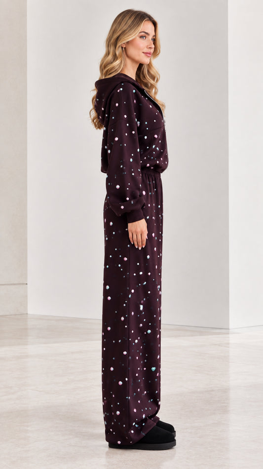 Side profile of burgundy rhinestone hooded fleece jumpsuit