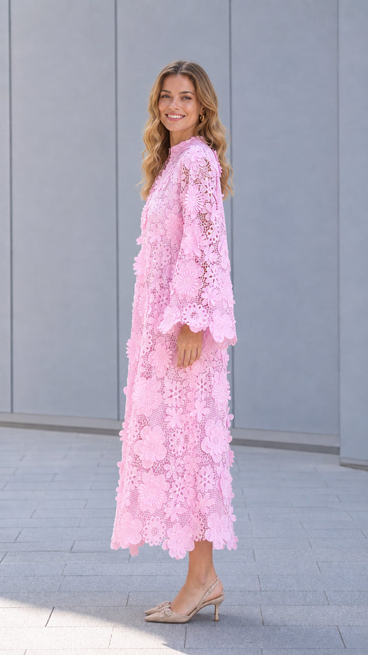 Side profile of model in pink lace dress