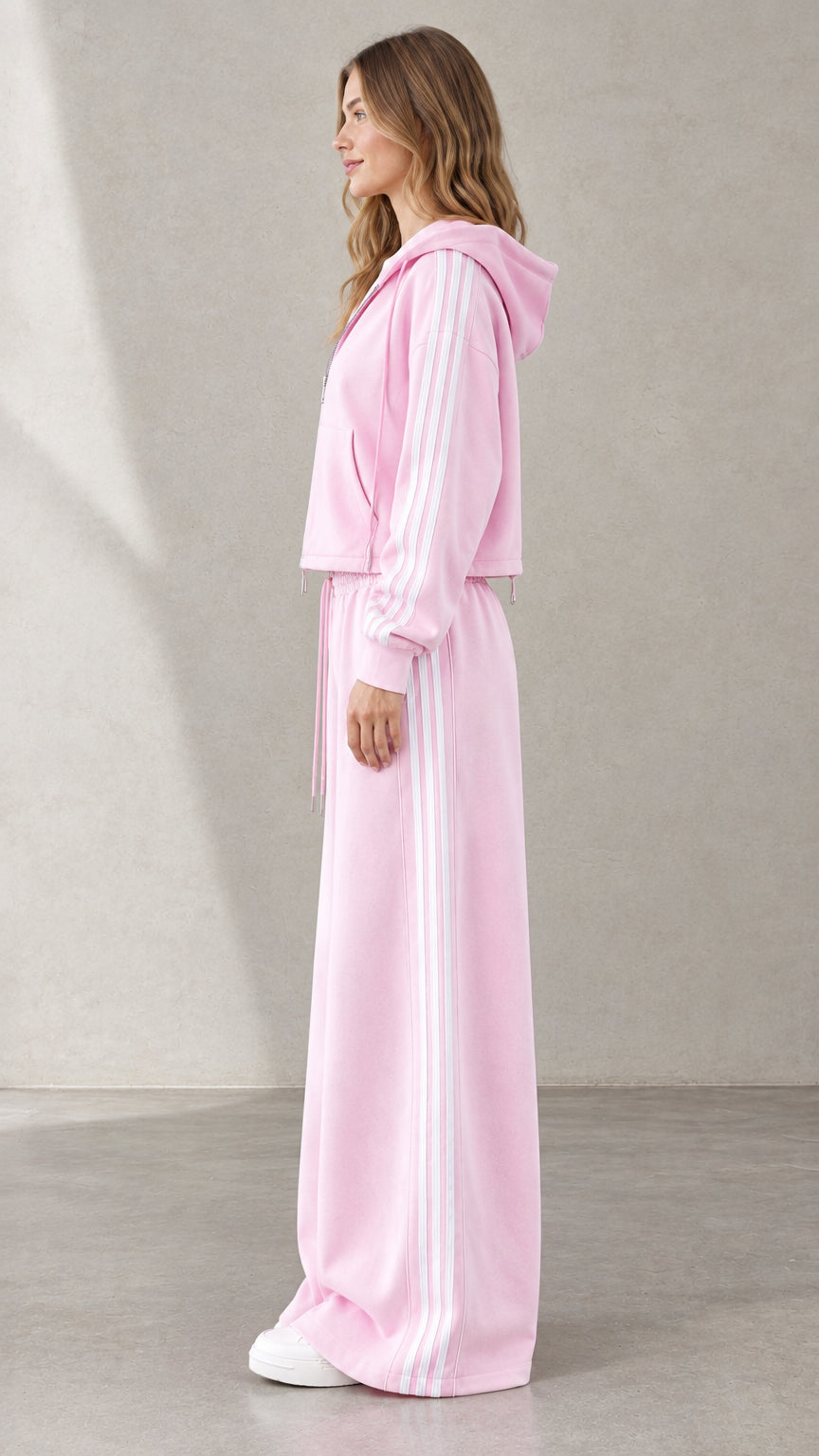 Side view of woman wearing Light Pink side-stripe hoodie and matching track pants