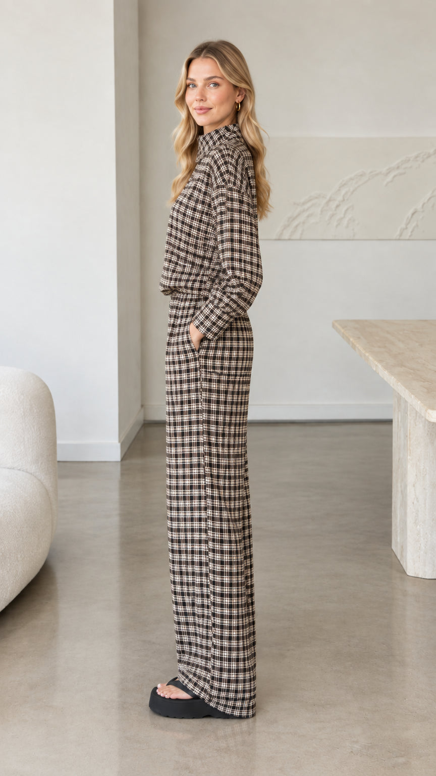 Side profile view of woman modeling brown check matching two-piece set