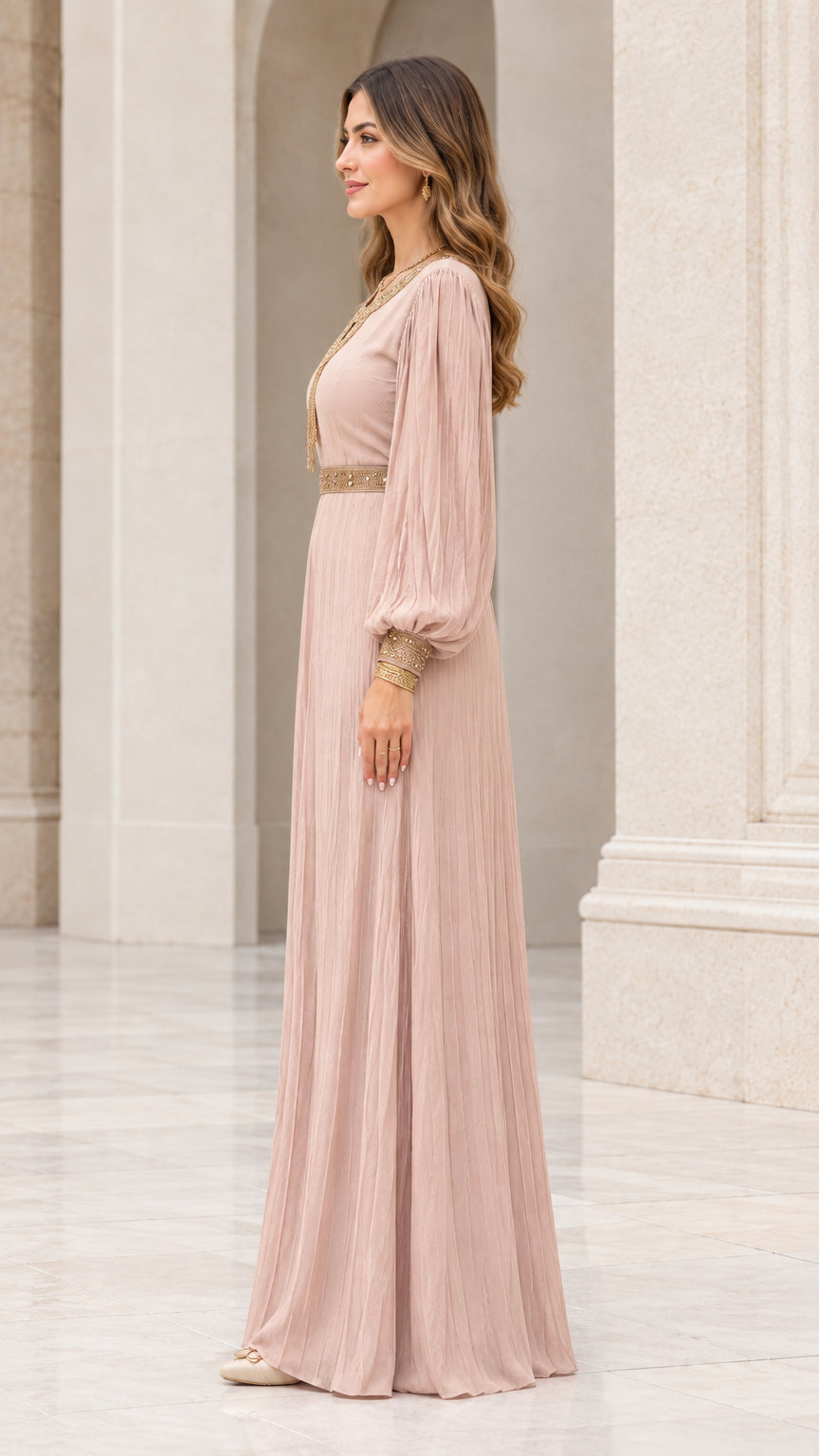 Side profile view of model in dusty rose pleated maxi gown with bishop sleeves