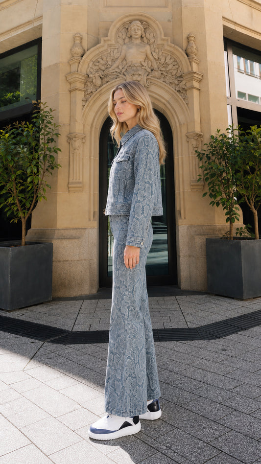 Side profile view of model in blue snake print denim coordinate set