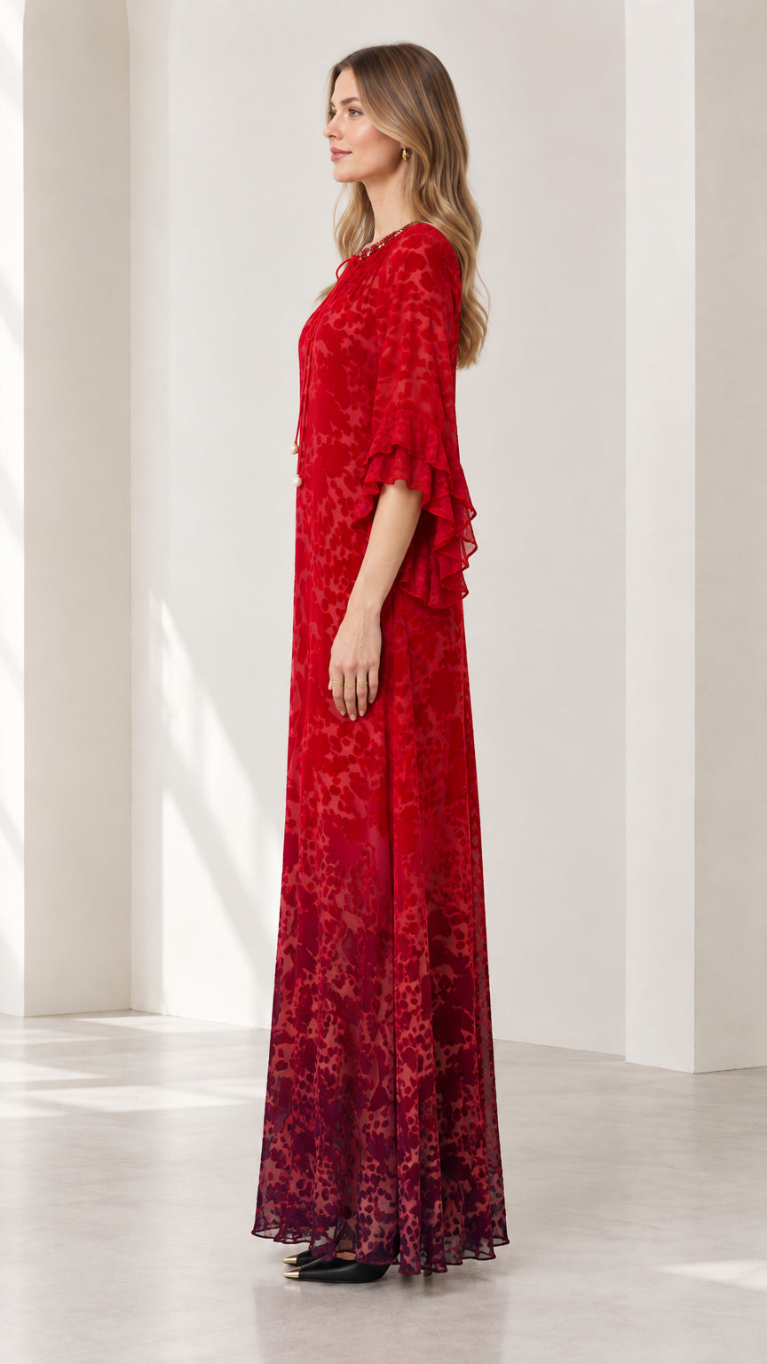 Side profile of model in Ruby Red floor-length dress showing elegant drape