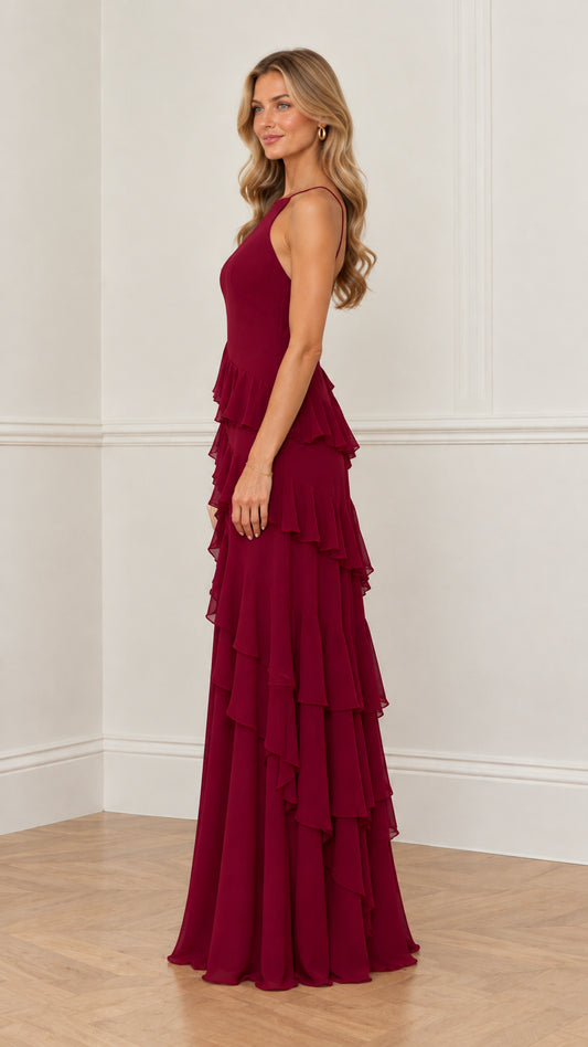Side profile view of burgundy halter tiered ruffle evening gown